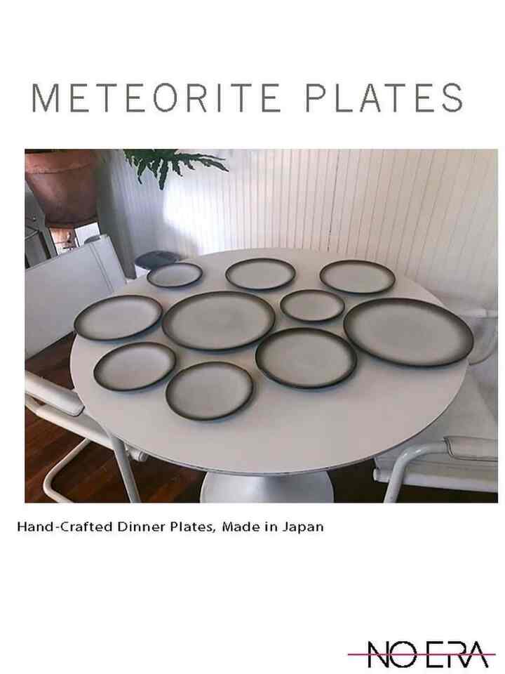 White round dining table featuring handcrafted Japanese plates in natural tones, creating a serene dining space