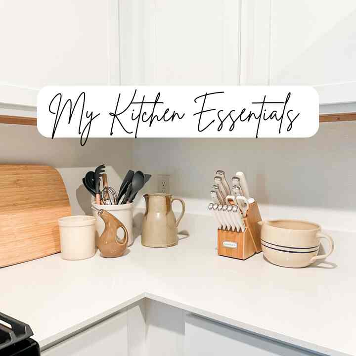 White and natural tone kitchen featuring organized utensils and knife set with a clean atmosphere