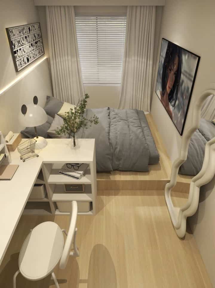 White and gray toned bedroom featuring minimal furniture and a workspace desk with a cozy, clean atmosphere