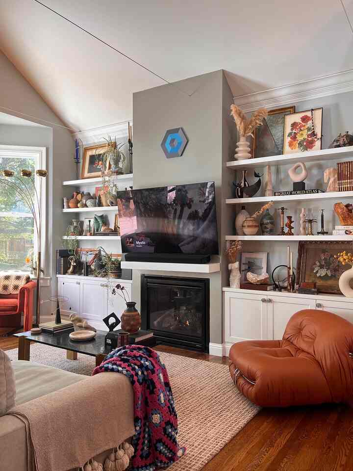 Beige and brown toned living room featuring fireplace and eclectic art objects in an open plan layout