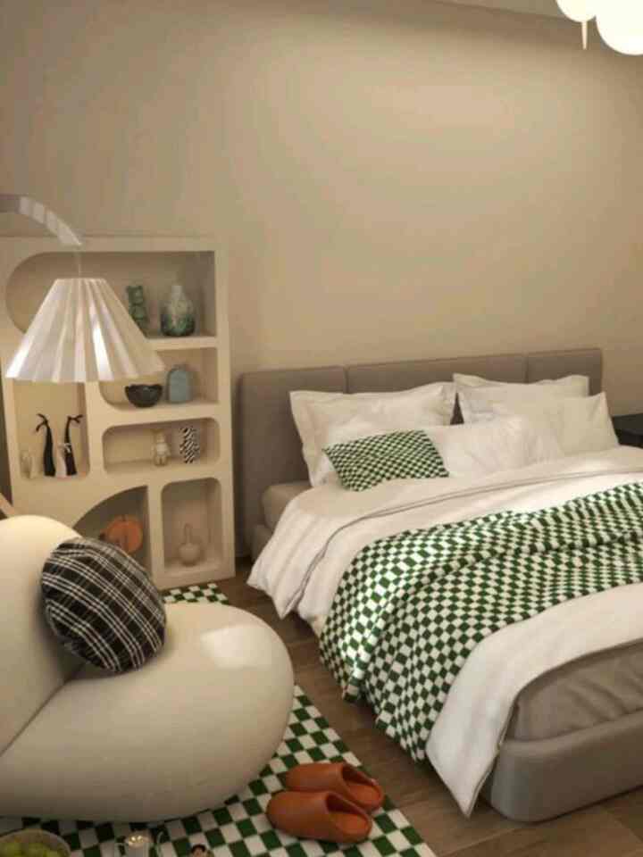 White and green toned bedroom featuring checkerboard blankets and rug with a cozy atmosphere