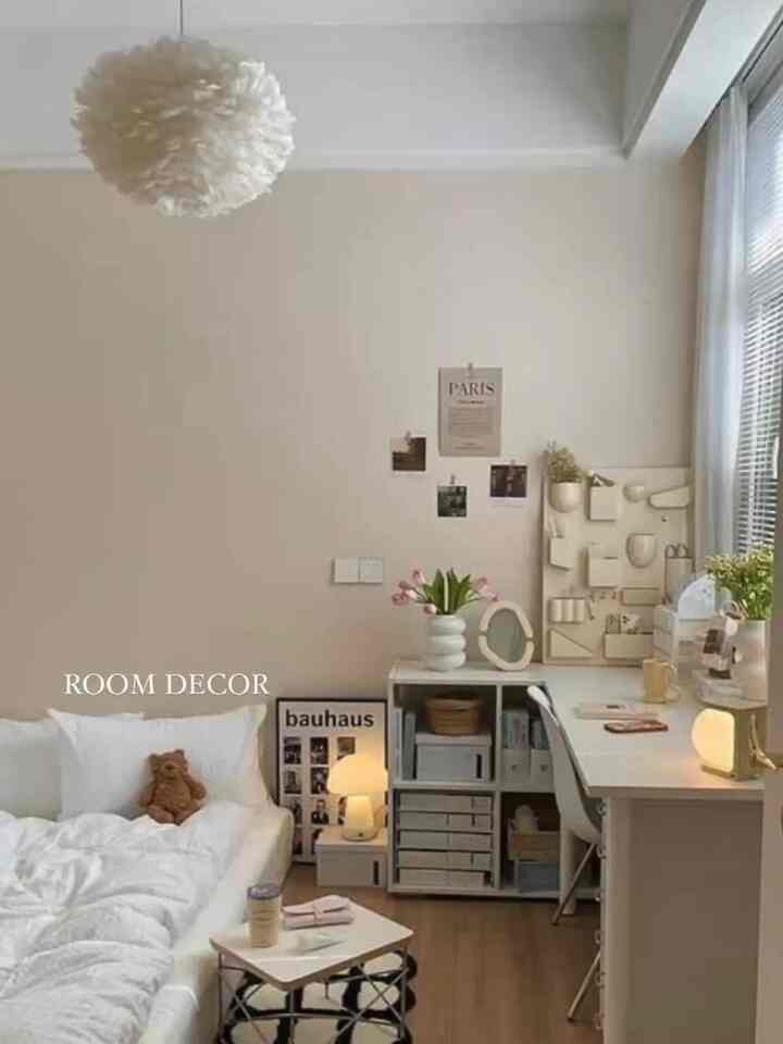 Beige-toned bedroom with white furniture, featuring a bed and desk arranged neatly in a clean, minimalist space