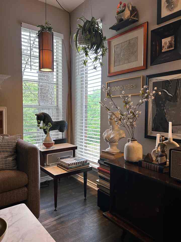Wood tone vintage-style living room featuring mid-century modern furniture and diverse wall decor in a cozy setting