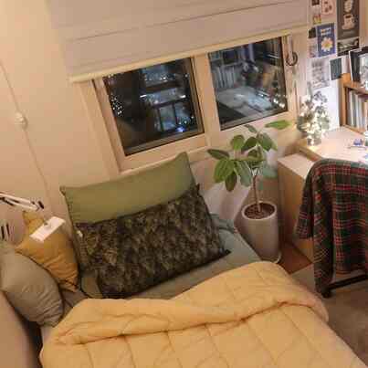 Cozy study space combining bedroom and home office in warm natural tones, featuring bed and desk harmoniously arranged