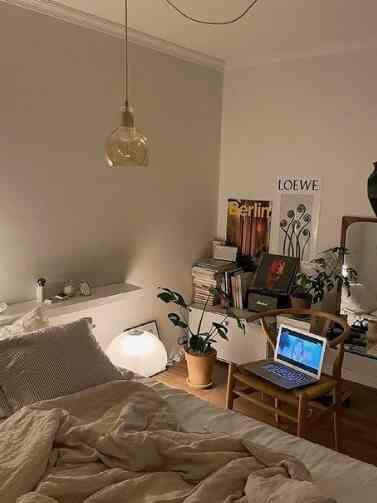 Natural tone 6畳 bedroom featuring wood furniture and plants, a single household setup with home office creating cozy atmosphere