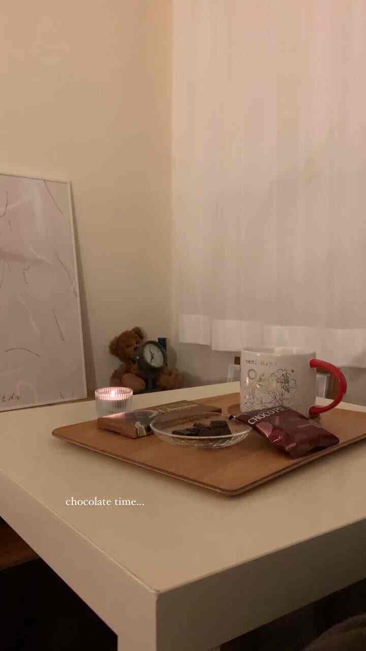 White-toned small 6-tatami room featuring a cozy single household space with candle, chocolates, and mug on a table