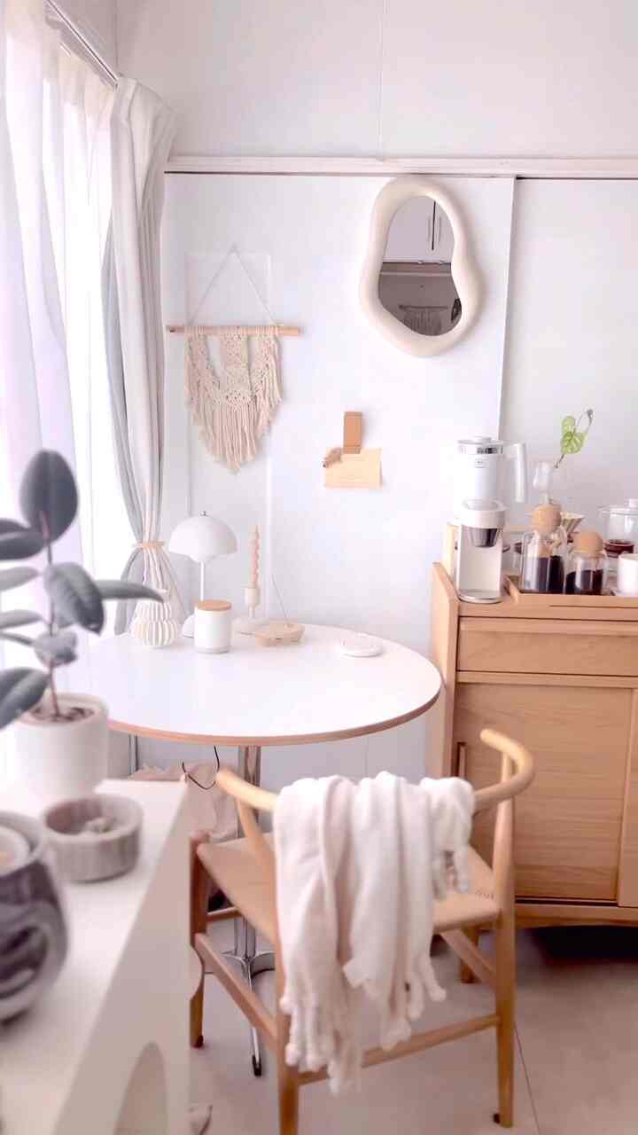Bright natural kitchen and home cafe with white and wood tones, featuring dining table and chair in a cozy setup