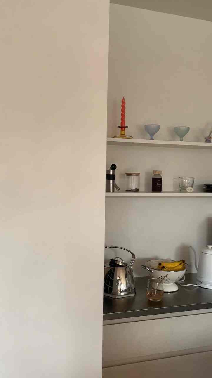 White and stainless steel kitchen space featuring simple and modern elements