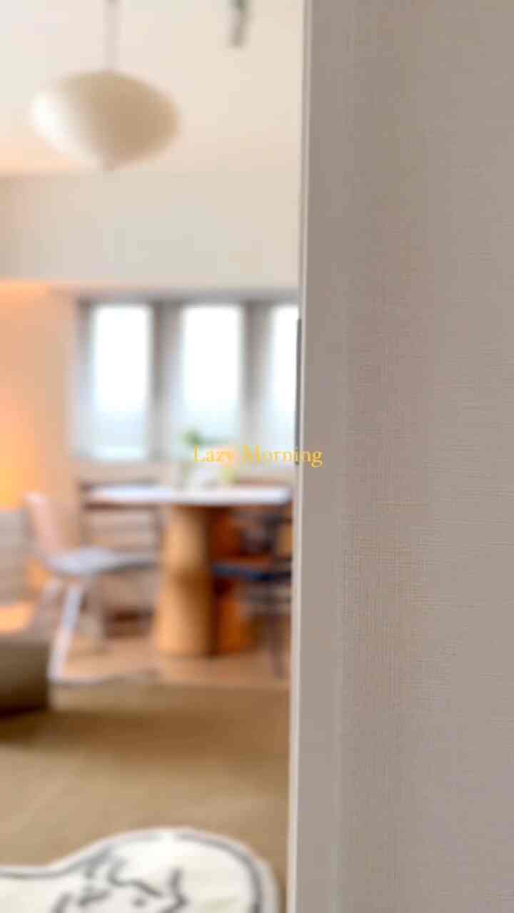 Beige and wood-toned dining room featuring round table and armchair arranged in a cozy space