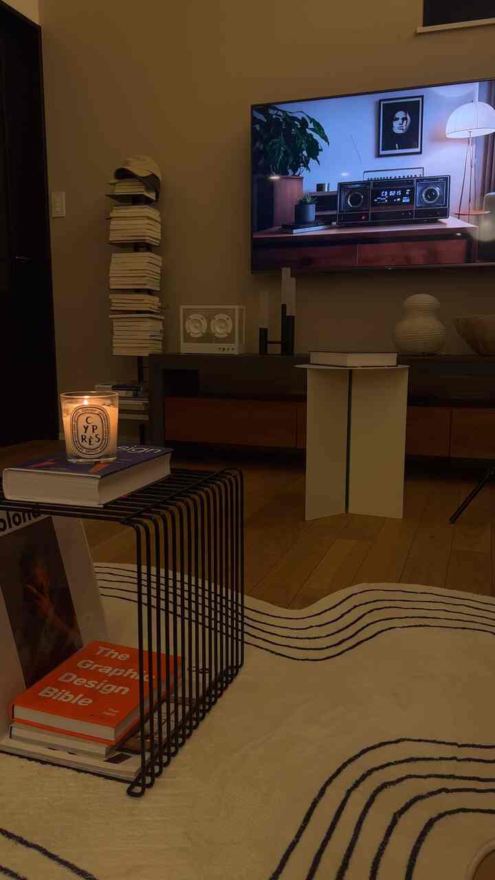 Warm brown-toned mid-century modern living room with books and candle arranged for cozy atmosphere