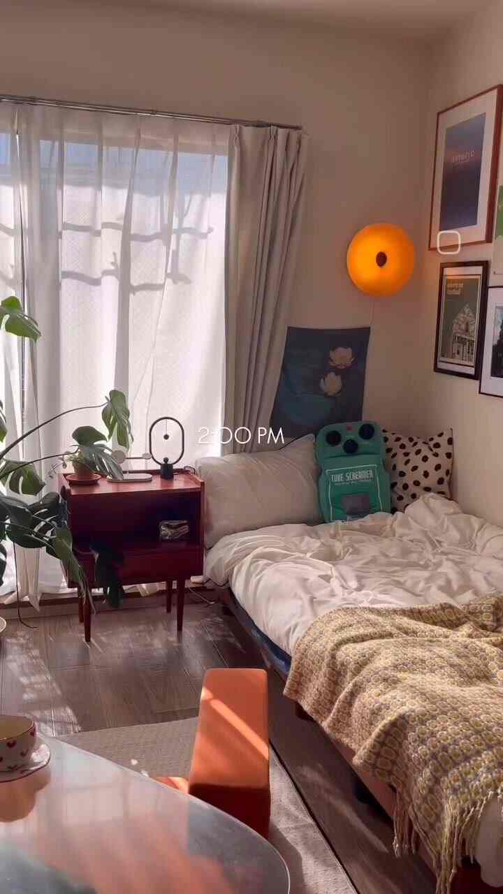 Warm beige tones and wood accents in an 8-tatami studio featuring a bed, plants, and indirect lighting creating cozy atmosphere
