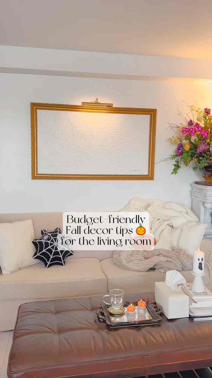 Cozy living room in soft beige and brown tones featuring a beige sofa and brown ottoman with warm fall decor accents