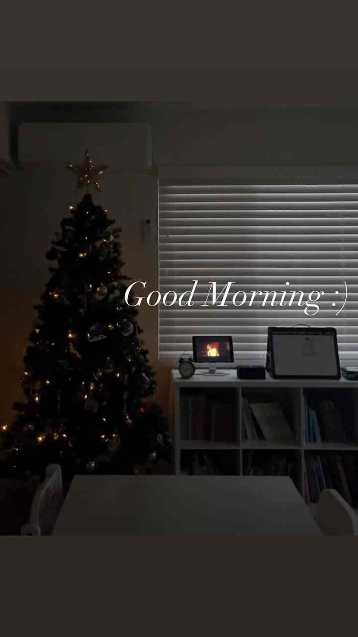 White and black toned living room featuring a Christmas tree and kids' table with cozy atmosphere