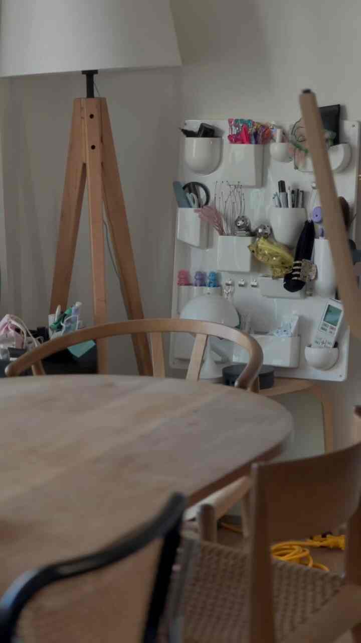 Natural wood-toned dining room featuring a floor lamp and wall storage organizer with a cozy atmosphere