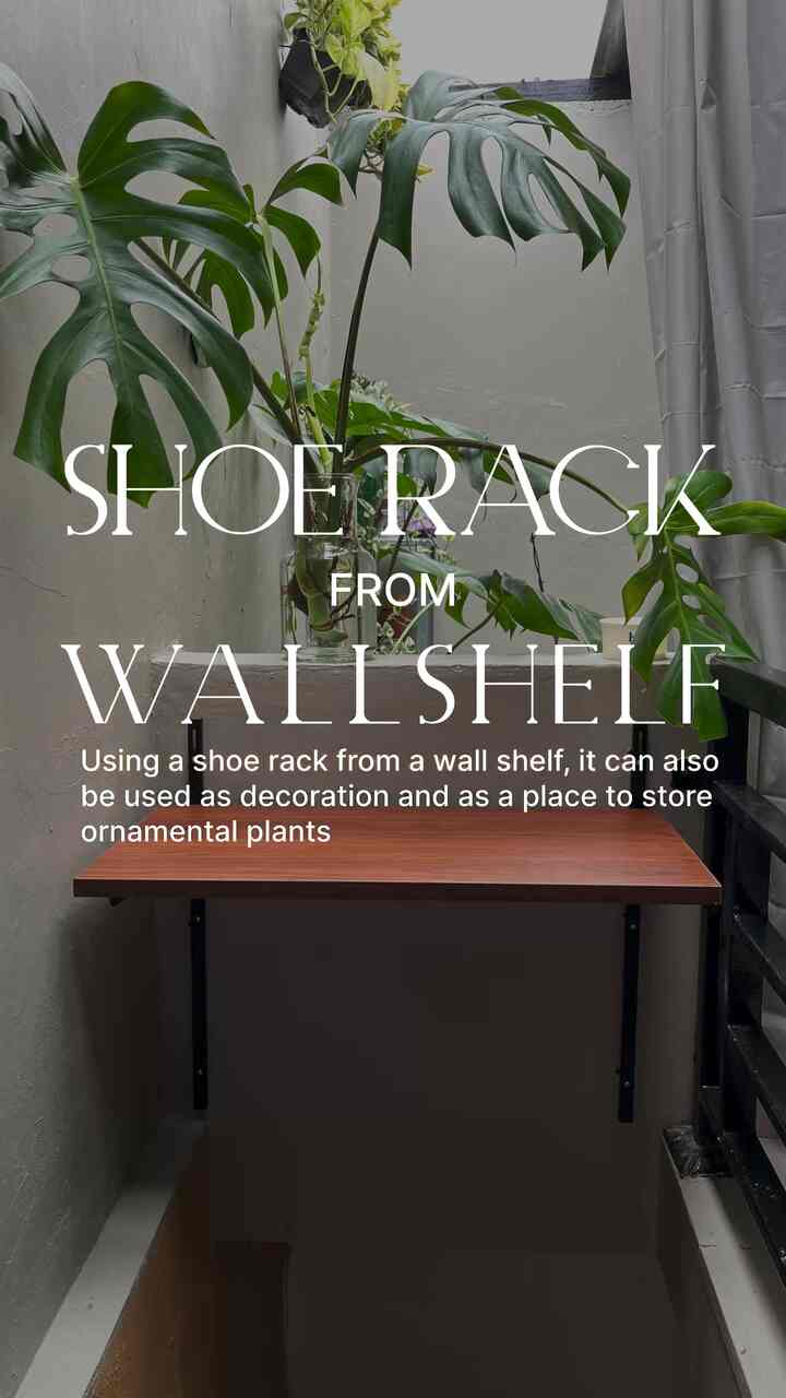 Natural color and wood-tone wall shelf in a narrow entrance space featuring green plants creating an airy atmosphere