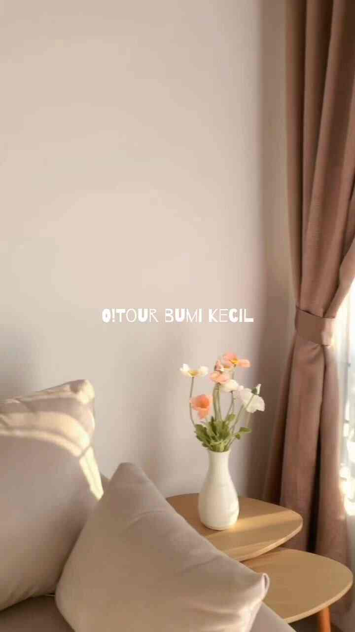 Natural-colored living room with beige curtains, sofa, and wooden nesting tables topped with a flower vase