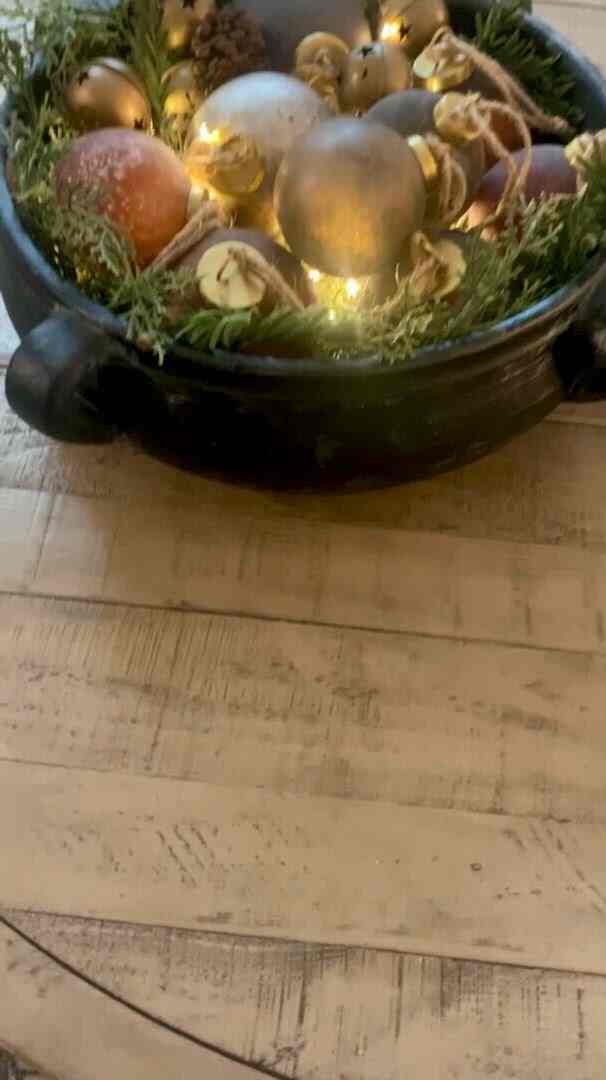 An easy Christmas centerpiece! Grab a large bowl and fill it with pine branches, ornaments, and fairy lights!  #christmasdecor #christmascenterpiece ￼