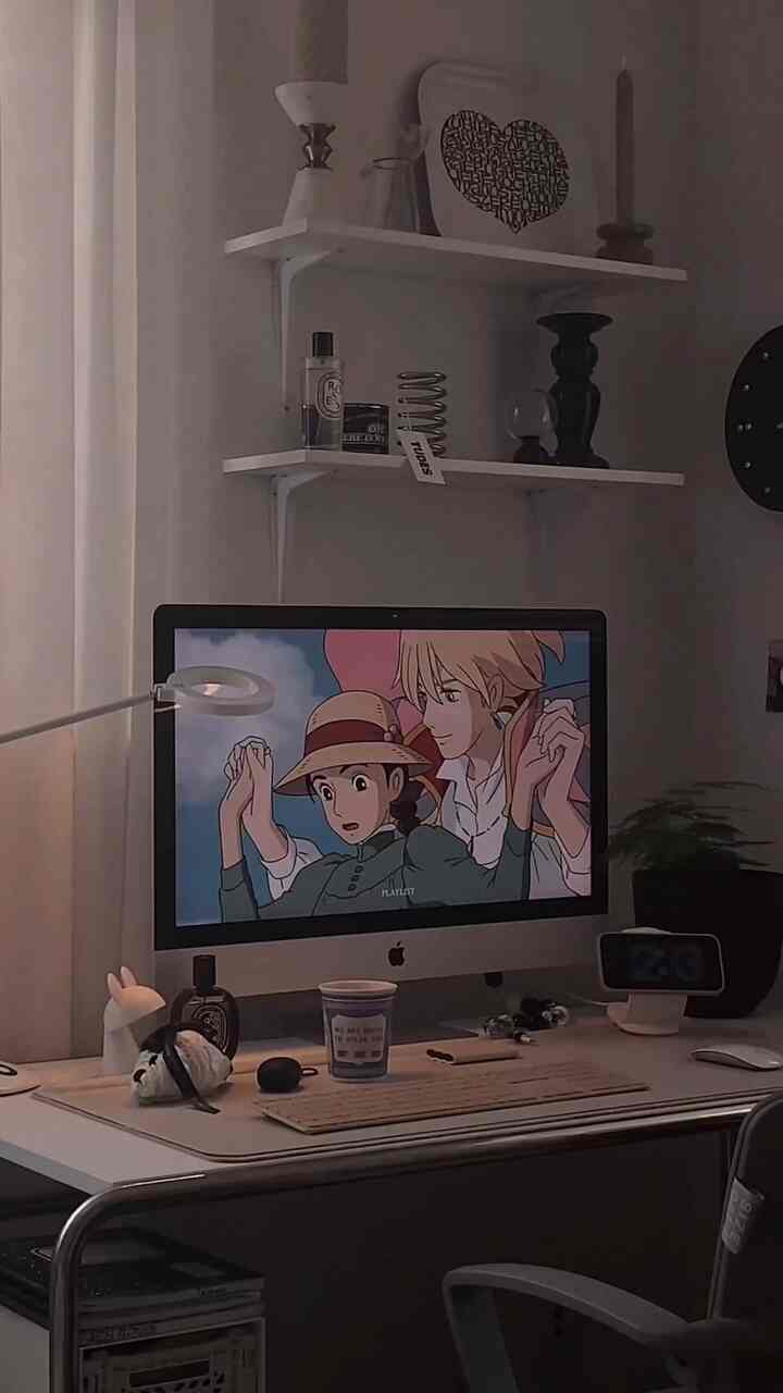 Monotone and white simple home office space featuring computer and shelves with minimalist decor