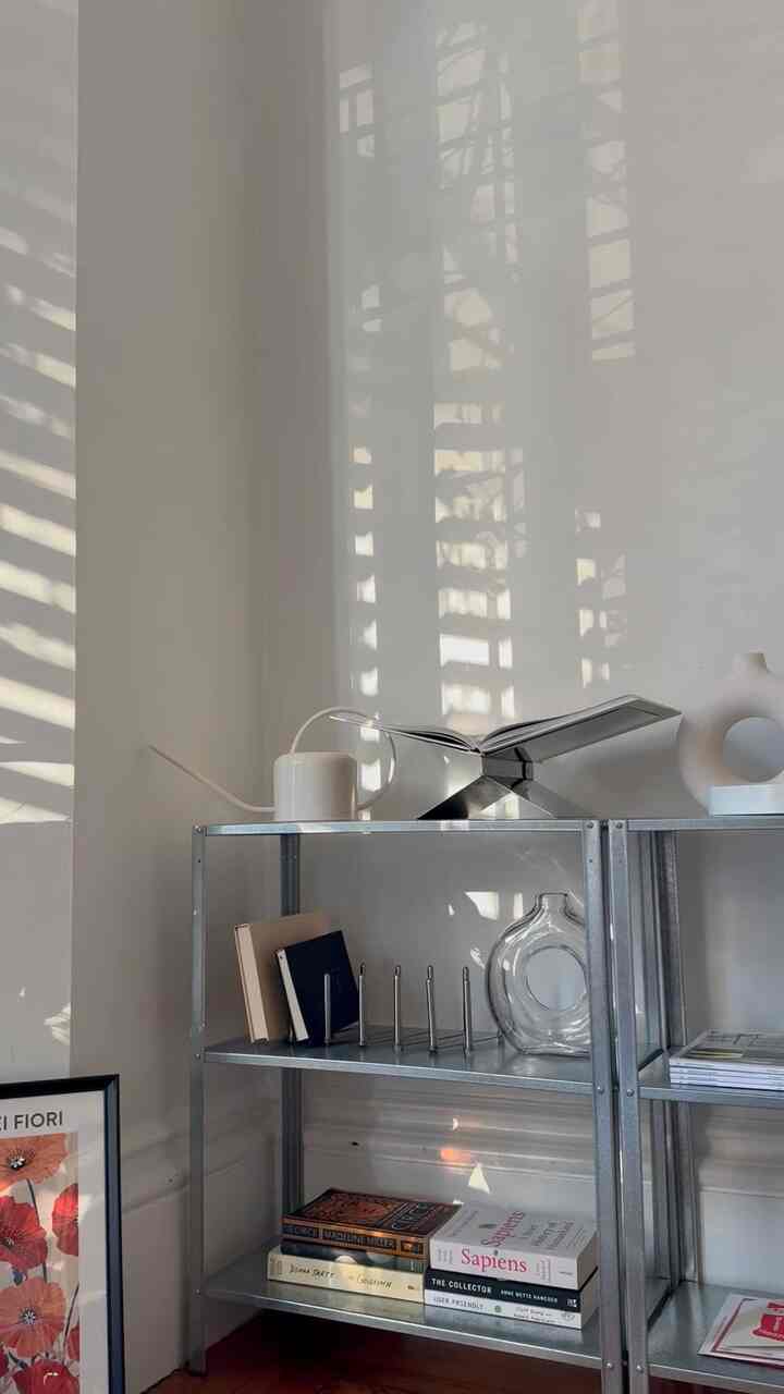 Golden hour shadows #frenchwindow #Frenchinterior #bookshelf #vase #wallart #art #book #shadow #sunlight #afternoon #livingroominterior #cozyroom #apartmentinterior 