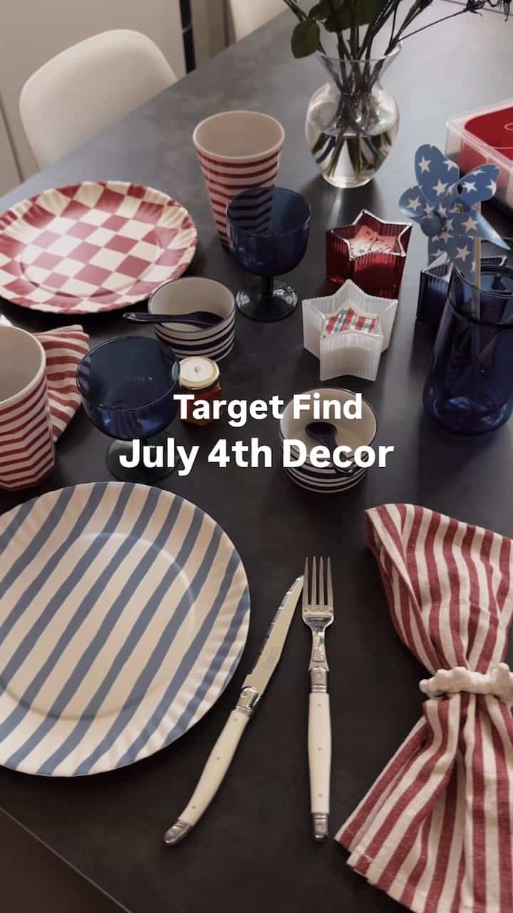 Red and blue striped patterned tableware and plates with candle decorations on a simple dining table