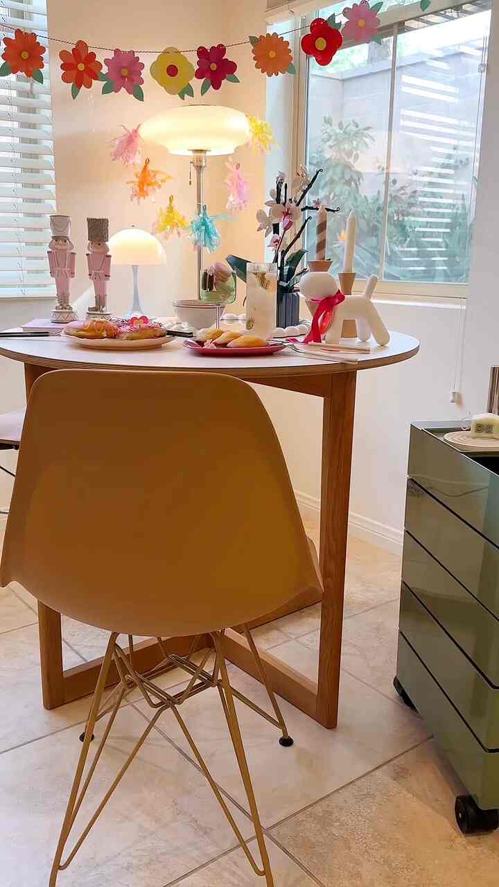 White and wood tone dining room featuring mid-century modern table and chair with a cozy home cafe vibe