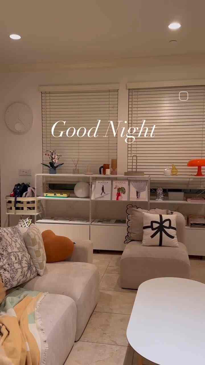 A white and beige toned living room featuring simple sofas and a coffee table creating a cozy atmosphere