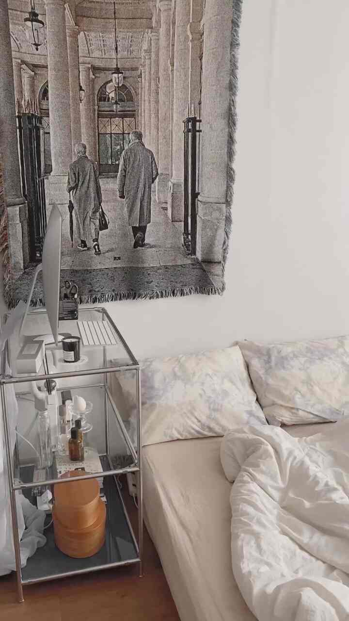 白とベージュの色調の寝室、シンプルな机と居心地の良い寝具が配置されたミニマルなインテリア