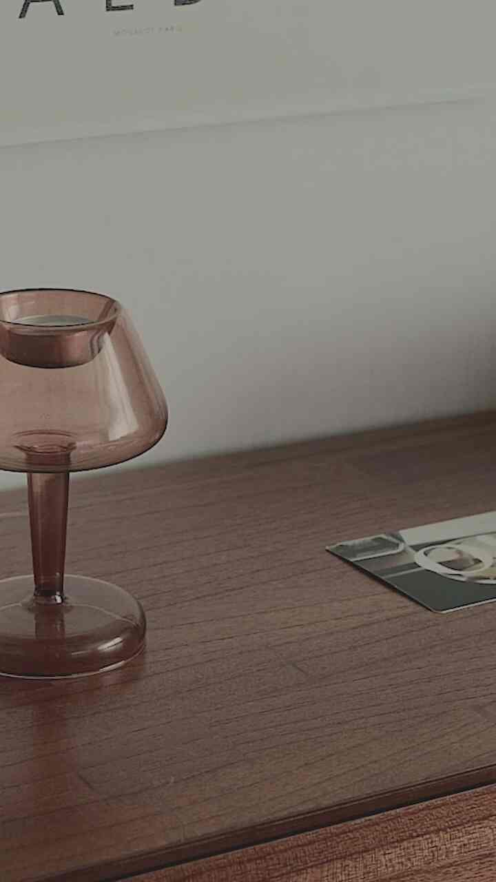 Natural brown wood tone furniture and wall posters create a serene study atmosphere