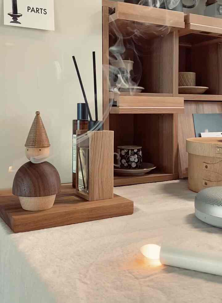 A cozy home cafe space featuring wood tones and beige colors with a mini cabinet and incense holder