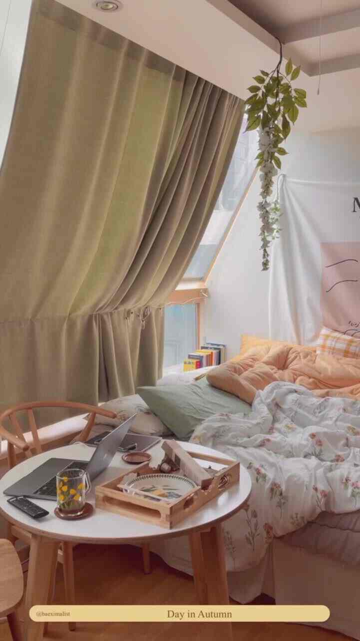 Beige blackout curtains and wooden furniture in a compact studio bedroom, cozy natural home cafe atmosphere