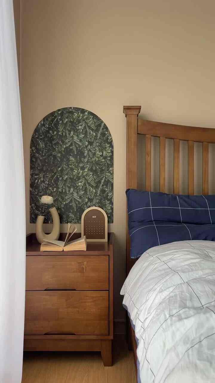 Natural color toned bedroom featuring wooden bed, nightstand, and an arch poster creating a calm atmosphere