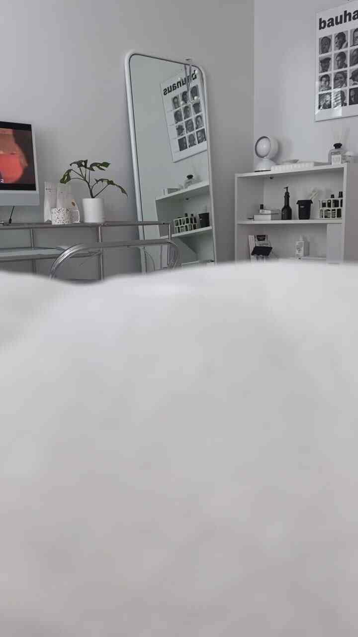 White-tone bedroom and home office space featuring transparent folding chair and mirror, with neat and Instagrammable interior