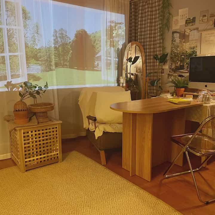 Warm wood tone living room featuring wooden furniture and plants with a cozy home cinema atmosphere