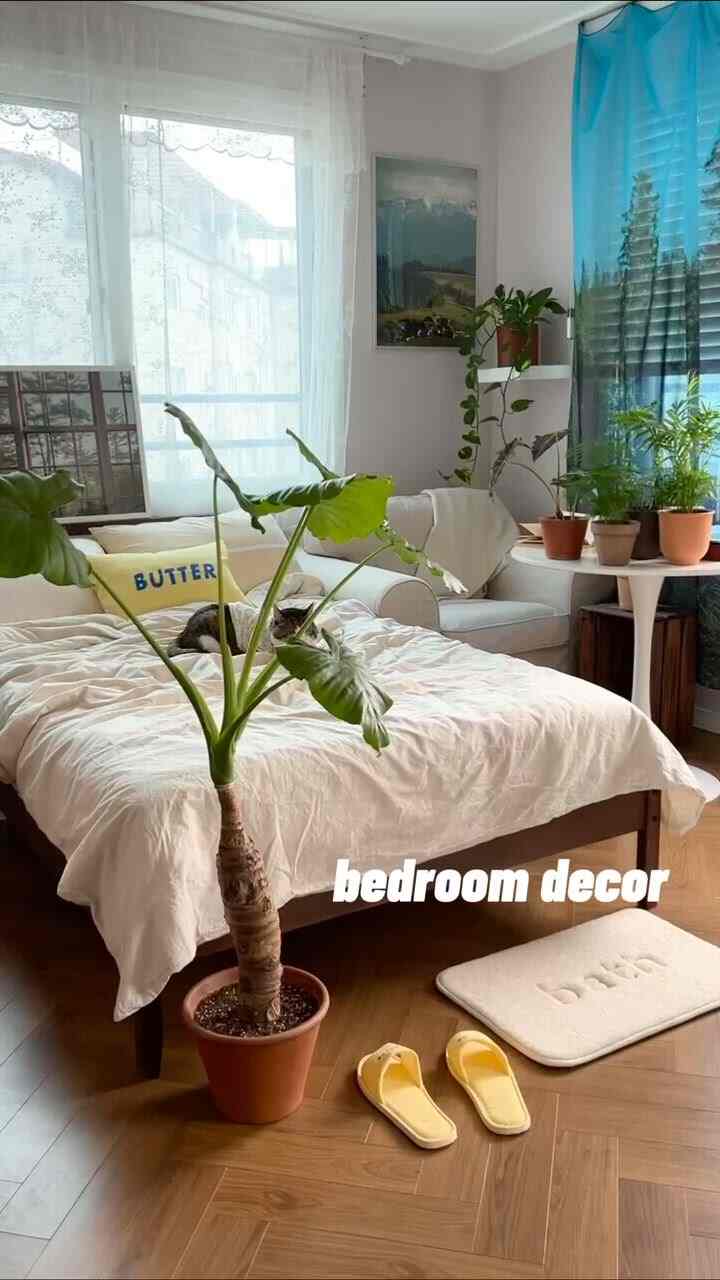 Natural-toned bedroom featuring wooden flooring and potted plants creating a cozy atmosphere