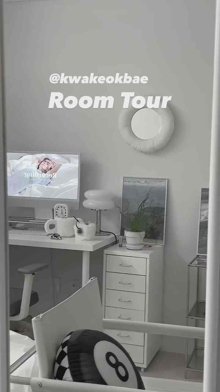 White-toned home office featuring a minimalist desk and white drawer unit in a clean interior setting