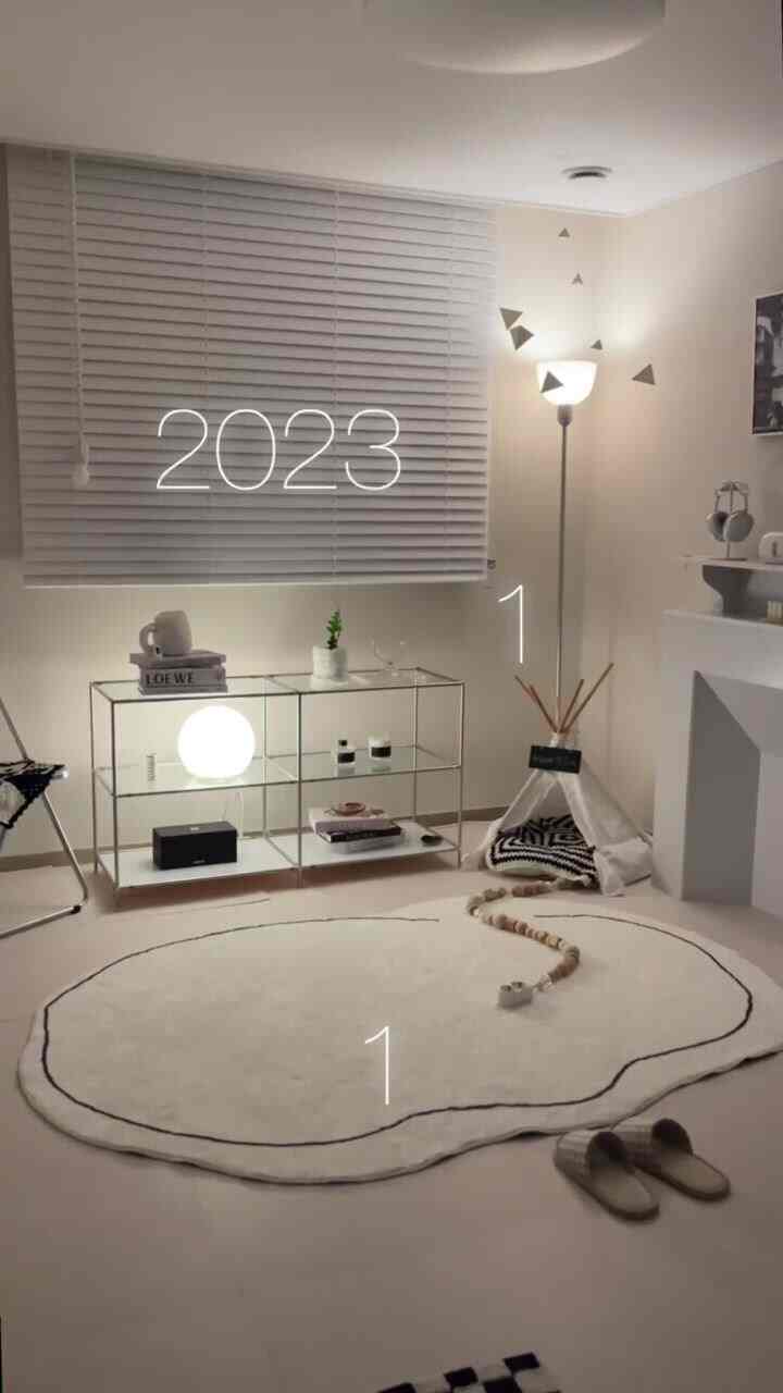 Natural and white toned simple living room featuring a pet house and floor lamp accent for a cozy atmosphere